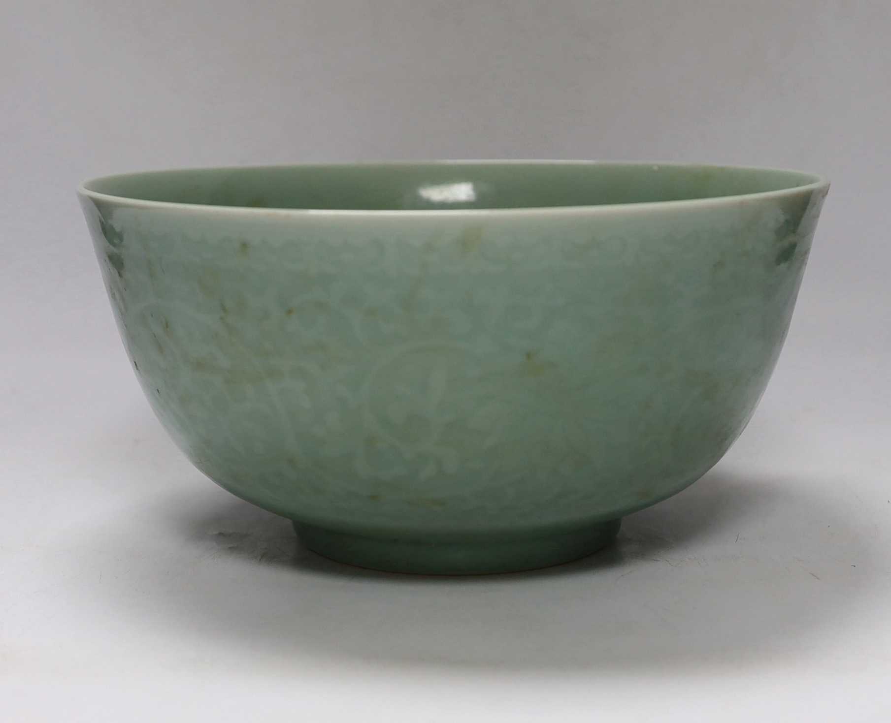 A Chinese celadon glazed ‘lotus’ bowl, 25cm diameter